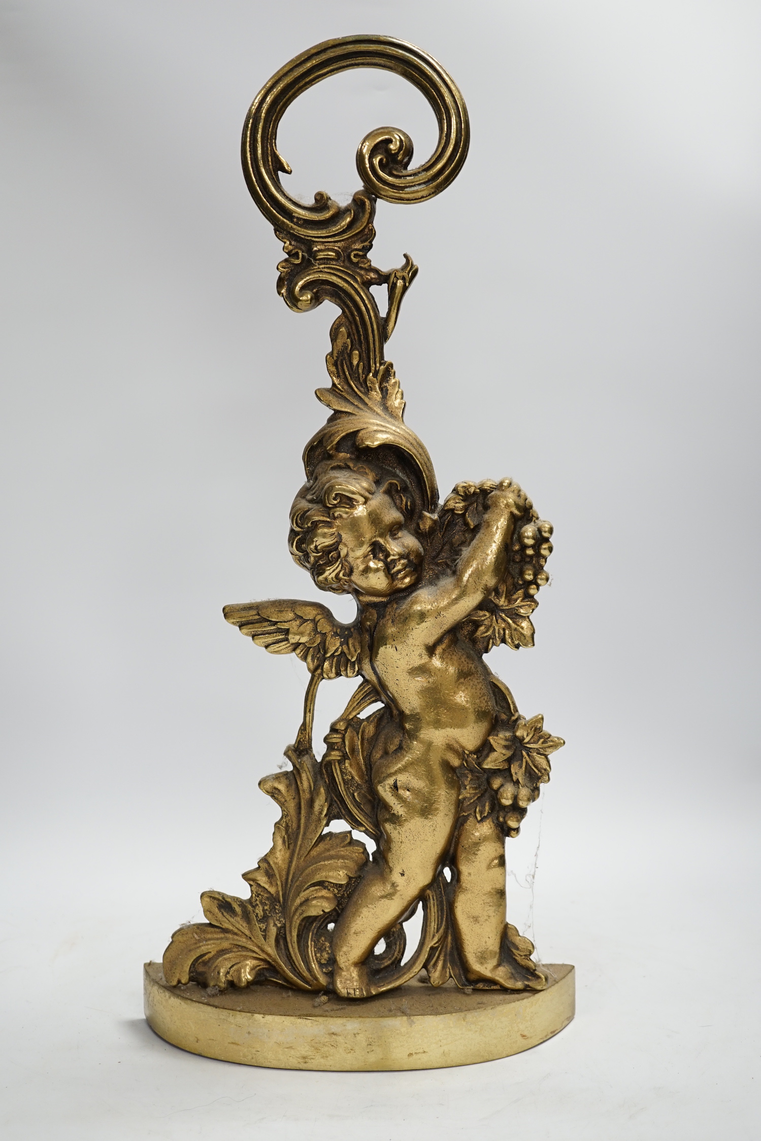 An Edwardian cast brass Cupid door porter, 49cm high